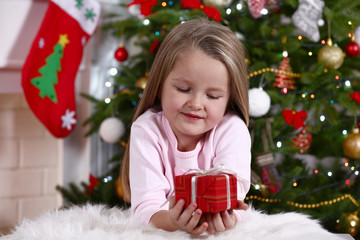 Little girl lying with gift
