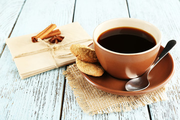 Cup of coffee with spoon and cookies