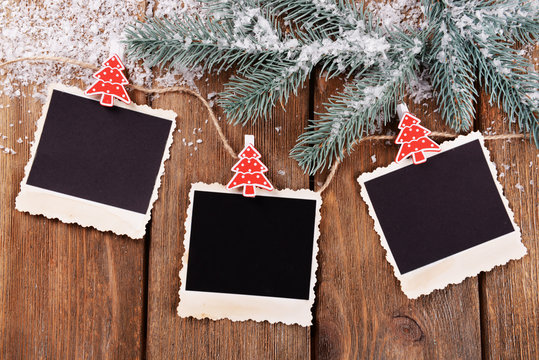 Blank photo frames and Christmas decor with snow fir tree