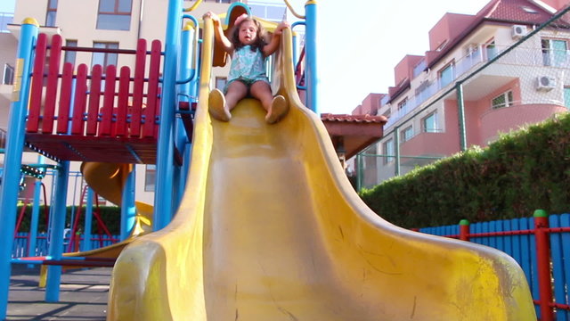 Young girl having fun on a slide
