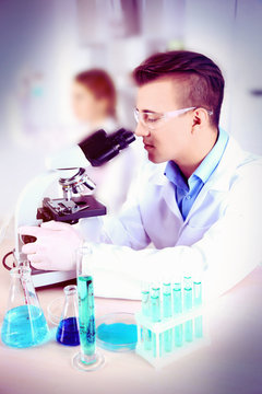 Young male researcher carrying out scientific research in lab