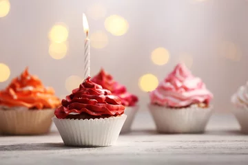 Gardinen Delicious birthday cupcakes on table on light background © Africa Studio