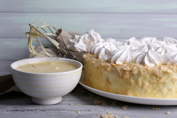 Tasty homemade meringue cake on wooden table