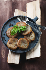 Potato pancakes or draniks in a frying pan, studio shot