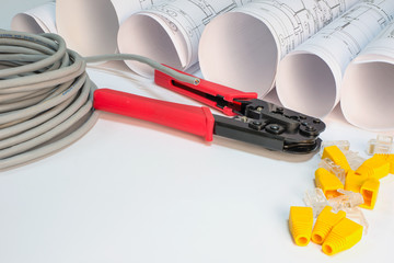 Drawing rolls, cat 5 cable, crimping pliers, connectors and boot