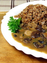 Buckwheat with mushrooms on plate - vegan meal