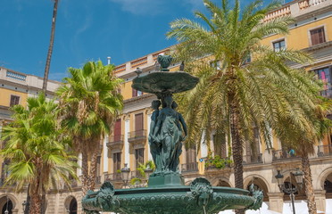 Obraz premium Old fountain with sculptures of one of squares of Barcelona