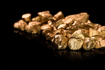 Gold nuggets on black background.
