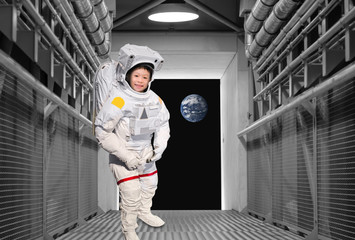 Astronaut boy  in the tunnels of the spacecraft.