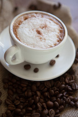 Cappuccino cup with coffee beans