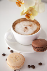 Cup of cappuccino with macaroon cookies