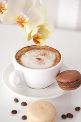 Cup of cappuccino with macaroon cookies