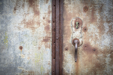 knob and lock of an ancient rusty metallic door