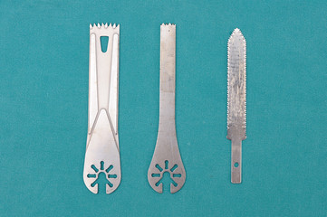 Surgery oscillating saw blades on green cloth.