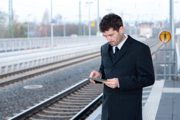businessman on railroad station