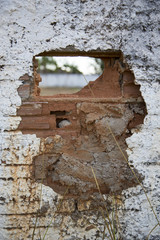 Hole in crumbling wall © creaceab