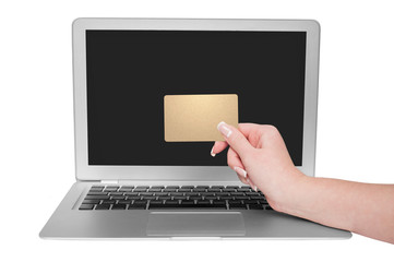 Woman holding gold credit card in hand. On-line shopping on the