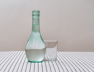 Rustic green glass carafe of water with drinking glass