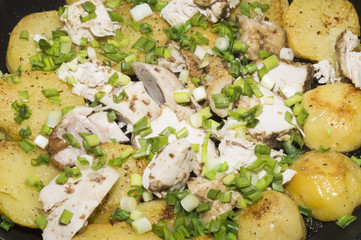 The fried potatoes and chicken with green onions