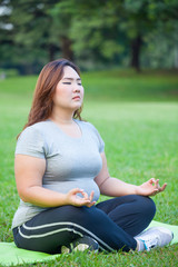 Plus size woman practicing yoga
