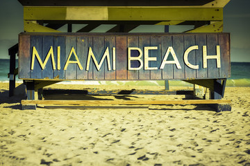 Miami Beach sign on wood background, Florida