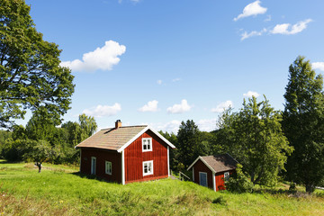 small red farm in rural country surroundings