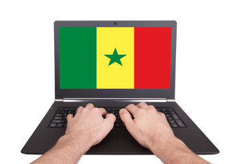 Hands working on laptop, Senegal