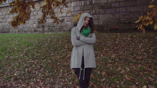 Sad woman with hoodie on boulevard, steadycam shot, slow motion 