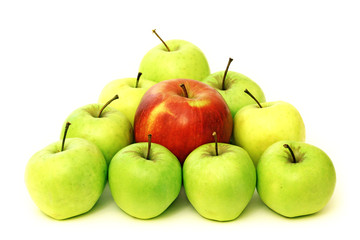 Triangle built of green apples and red apple in centre