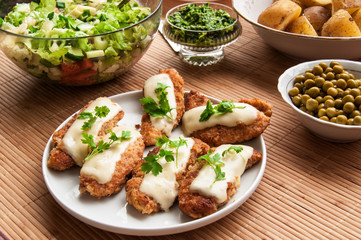 Fried chicken with salad and potatoes