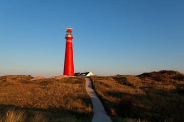 road to red lighthouse and blue sky