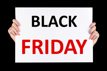 Hands holding Black Friday advertising isolated on black