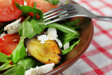 Eggplant salad with tomatoes, arugula and feta cheese,