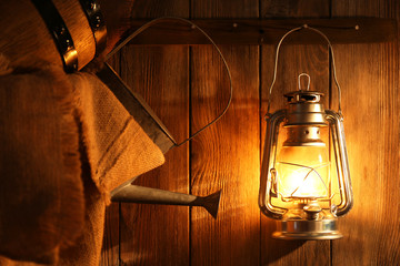 Fototapeta na wymiar Lantern hanging on hook on wooden wall