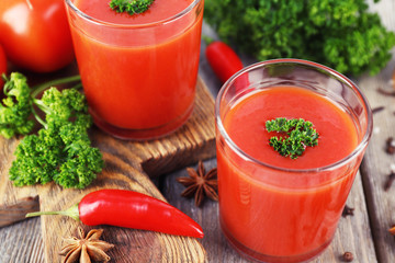 Tomato juice in glasses and fresh vegetables