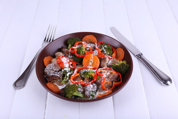 Braised wild mushrooms with vegetables and sauce in plate