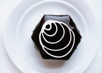 Yummy chocolate cupcake on plate close-up