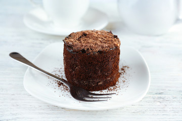 Yummy chocolate cupcake on table