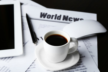 On-line news concept. Computer mouse, PC tablet, cup of coffee