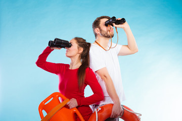 lifeguards on duty looking through binoculars
