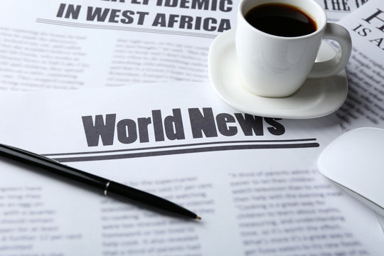 On-line news concept. Computer mouse, cup of coffee and