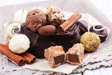 Pile of chunk of chocolate and truffles with cinnamon stick