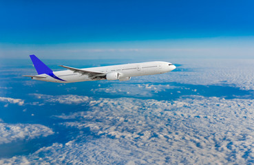 Fototapeta na wymiar Passenger airplane flying above dramatic clouds