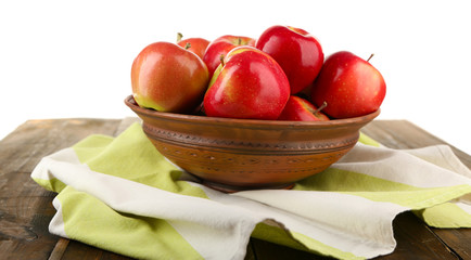 Bowl of red apples on wooden table, isolated on white