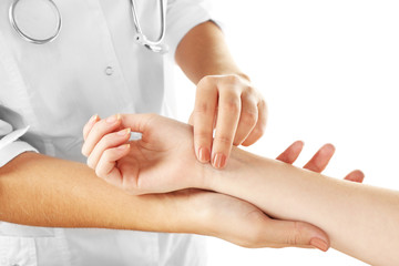 Checking pulse by hand isolated on white