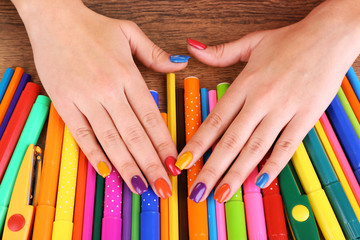 Fototapeta premium Multicolor female manicure with markers and pencils