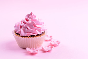 Delicious cupcake on pink background