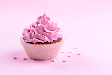Delicious cupcake on pink background