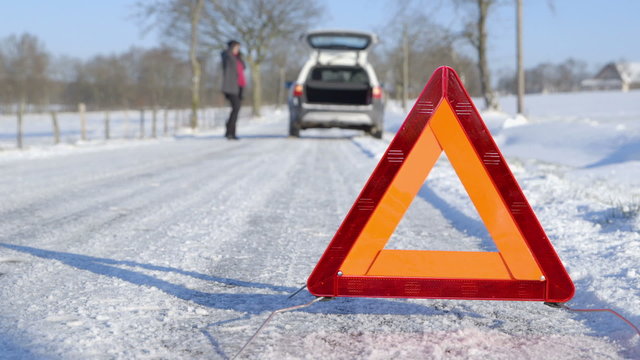 Winter Driving - Car Trouble - Woman calling roadside assistance