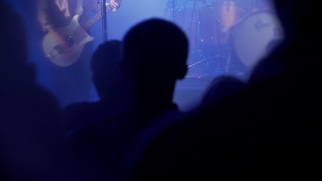 People listening rock star on concert in the club